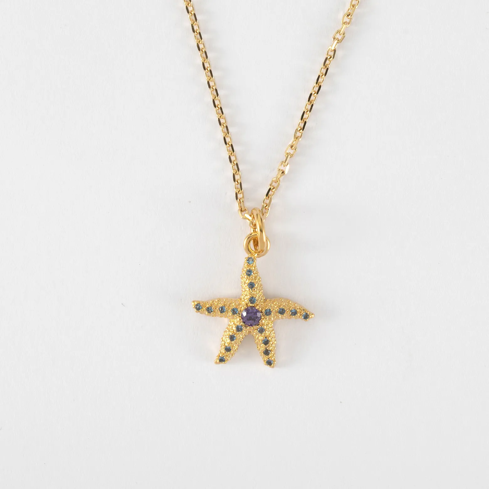 Pendentif étoile de mer scintillante zircons bleus plaqué or 15 mm