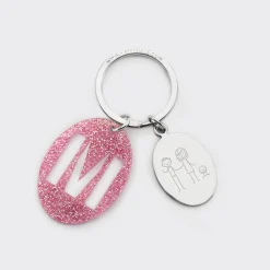 Porte-clés personnalisé médaille gravée ovale acier et breloque initiale acrylique pailleté rose